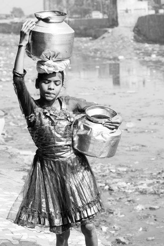 Human Right to Water in India - A slum-dwelling girl assisting her family with domestic water procurement in Mumbai, Maharashtra
